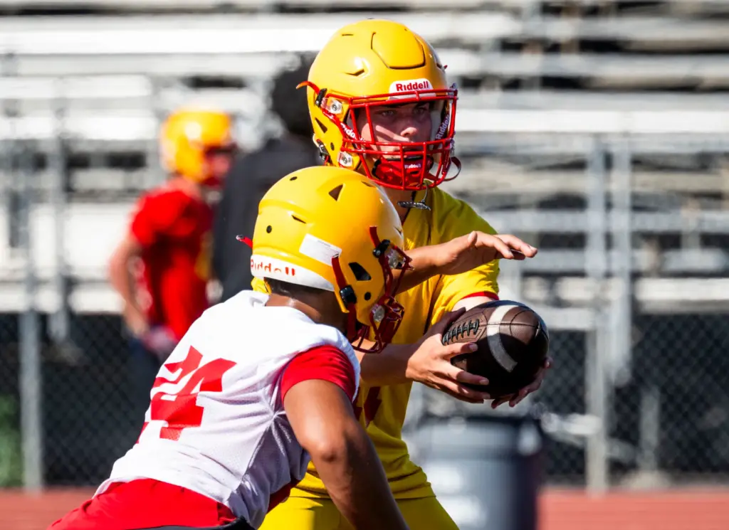 Mission Viejo High School quarterback Beckham Sharpe runs plays during...