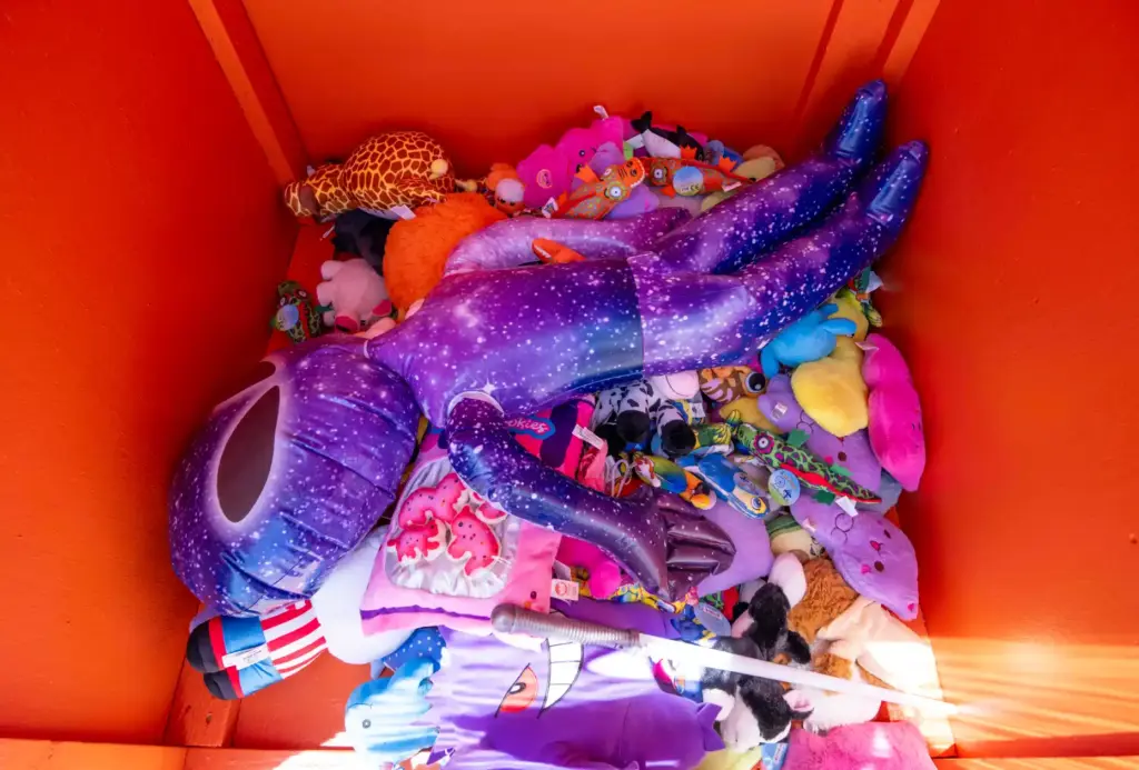 A pile of donated prize winnings lay in a collection...