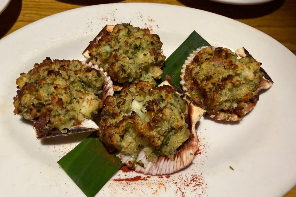 A stuffed scallop appetizer is seen at Damonâs in Glendale,...