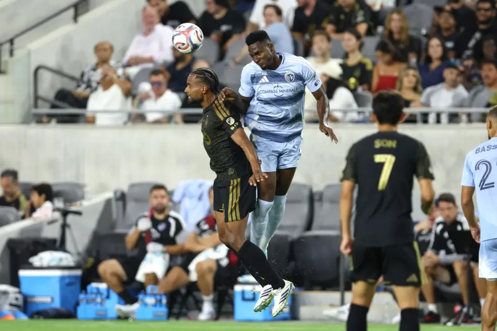 Los Angeles FC defender Eddie Segura, left, heads the ball...
