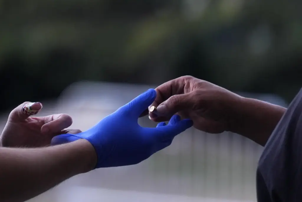 A vendor, right, who found a bullet casing, gives it...