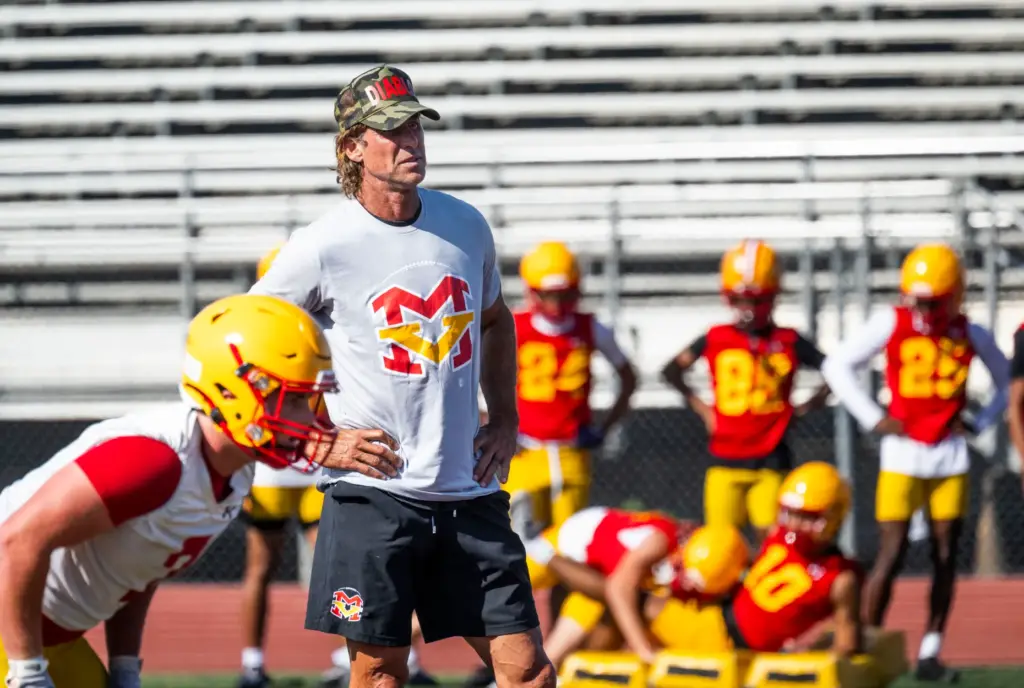 Mission Viejo High School coach Rob Johnson works with the...