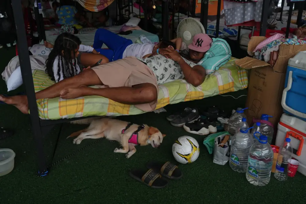 A family rests at a sports center being used as...