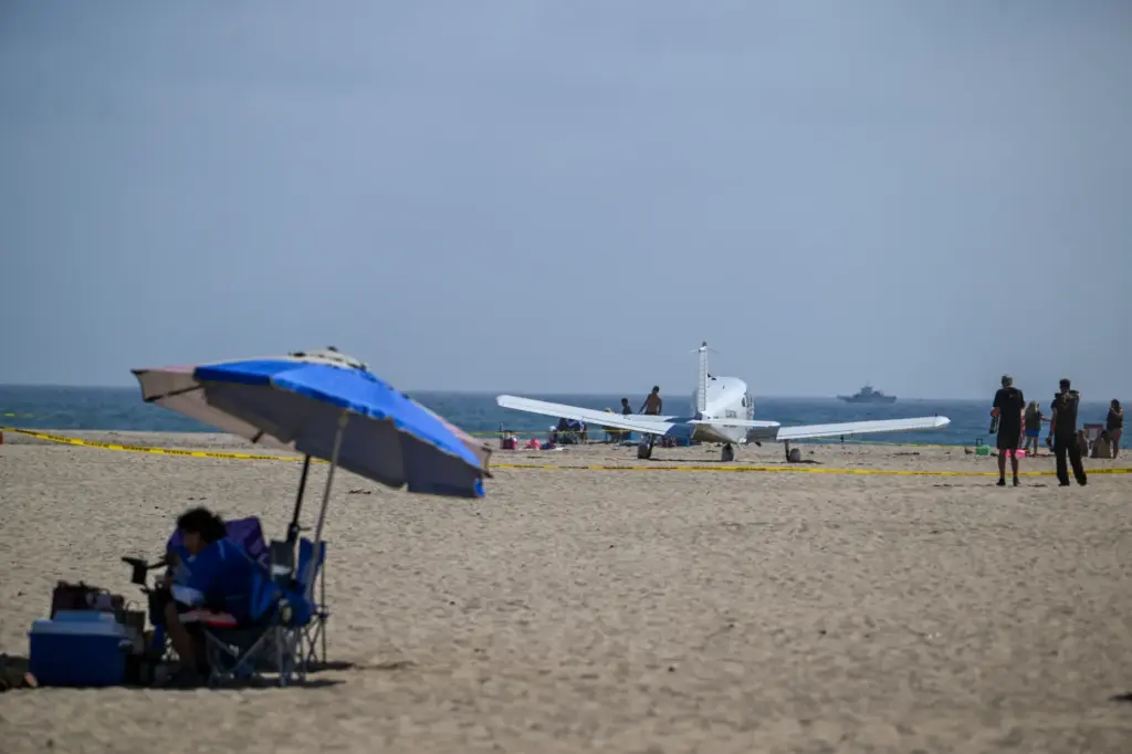 A Piper Cherokee 140 sits on the sand after an...