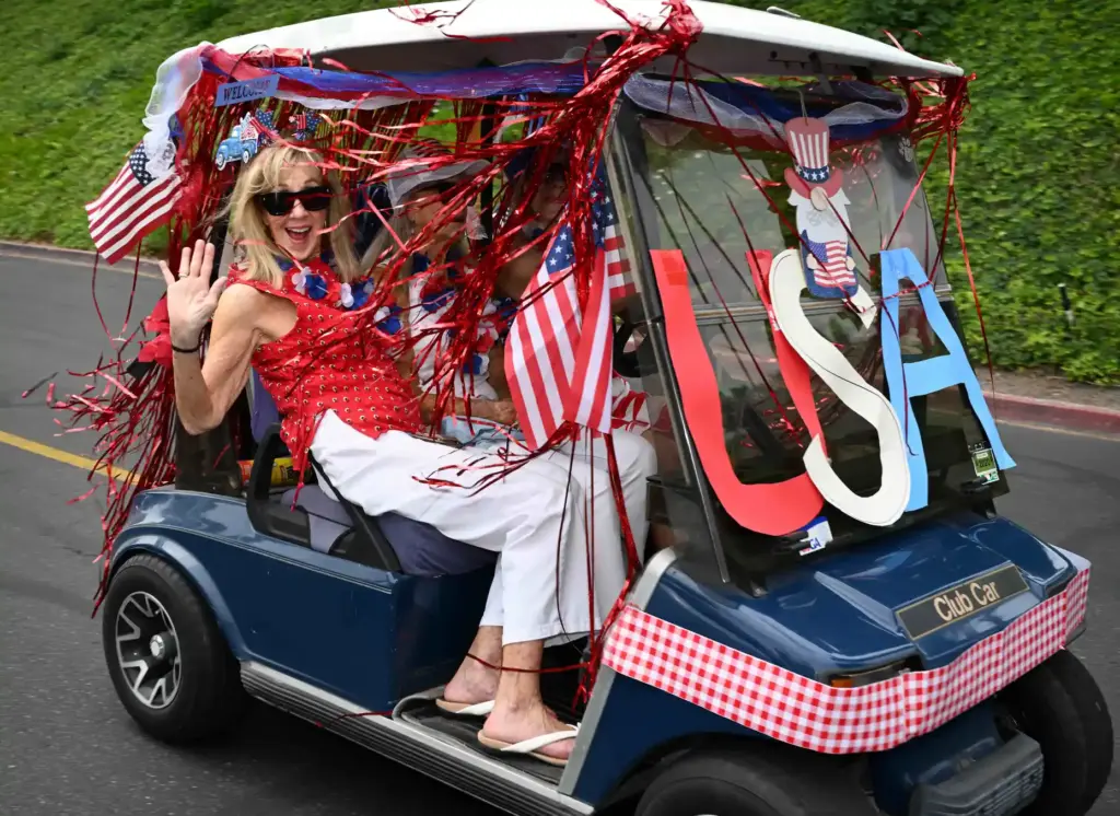 Decorated golf carts ride down Calle Aragon road during the...