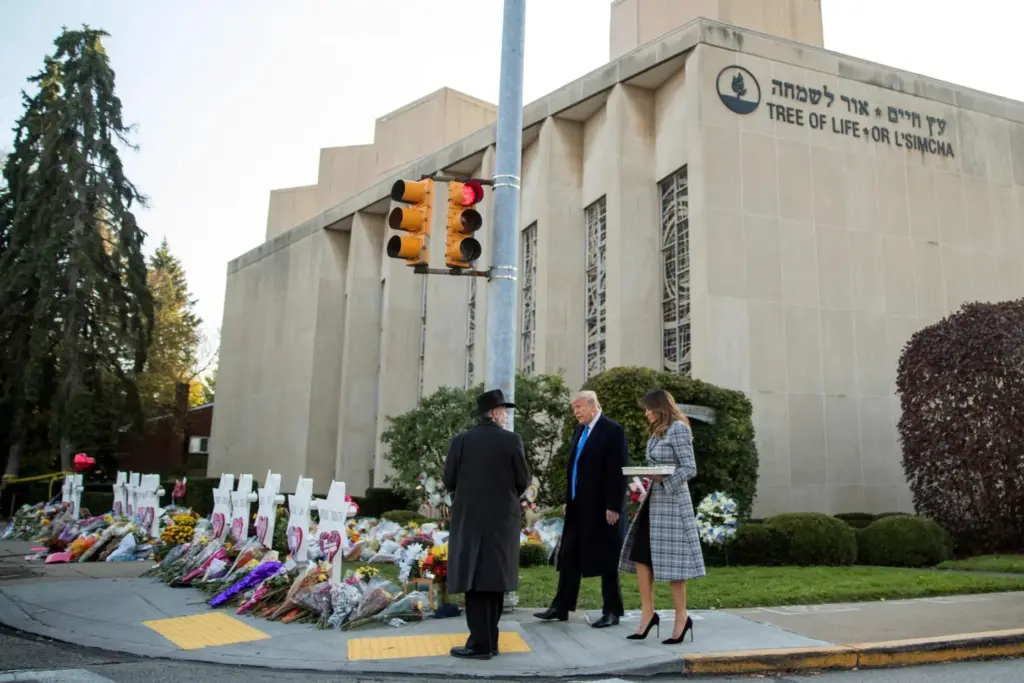 FILE – Tree of Life Rabbi Jeffrey Myers, left, walks...