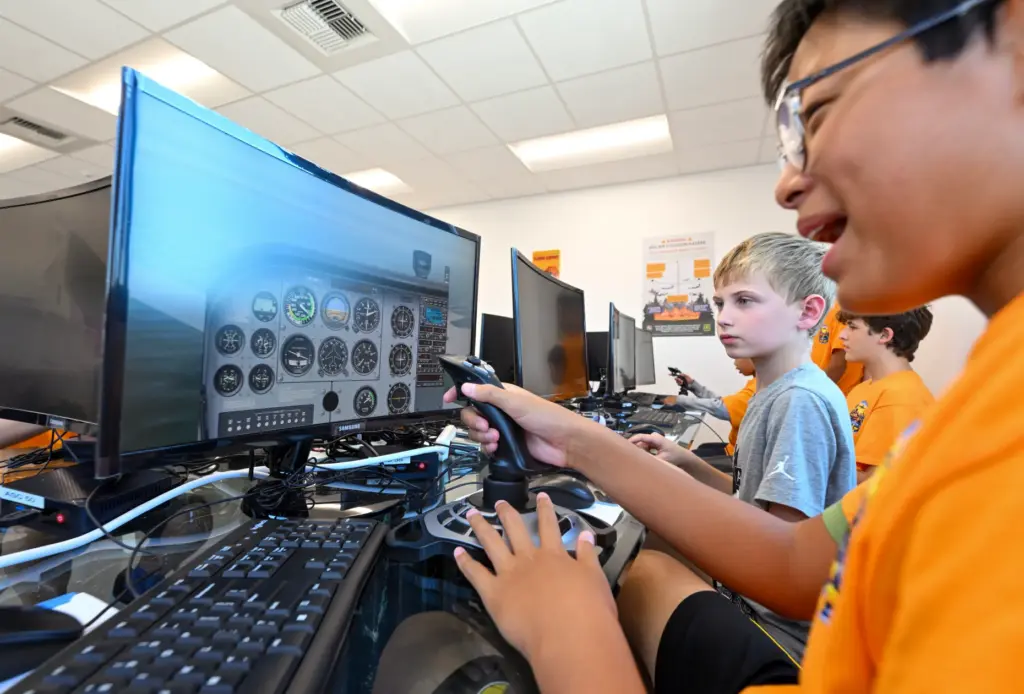 Camper Mark Du flies a flight simulator during Aviation Summer...