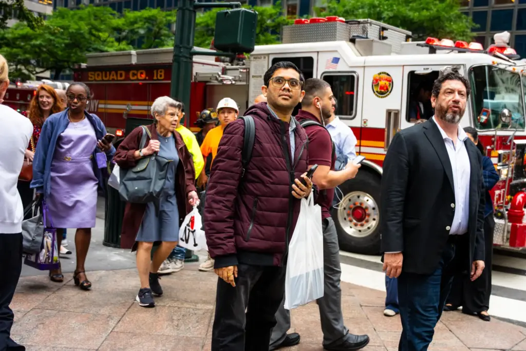 People gather near East 42nd Street after buildings in the...