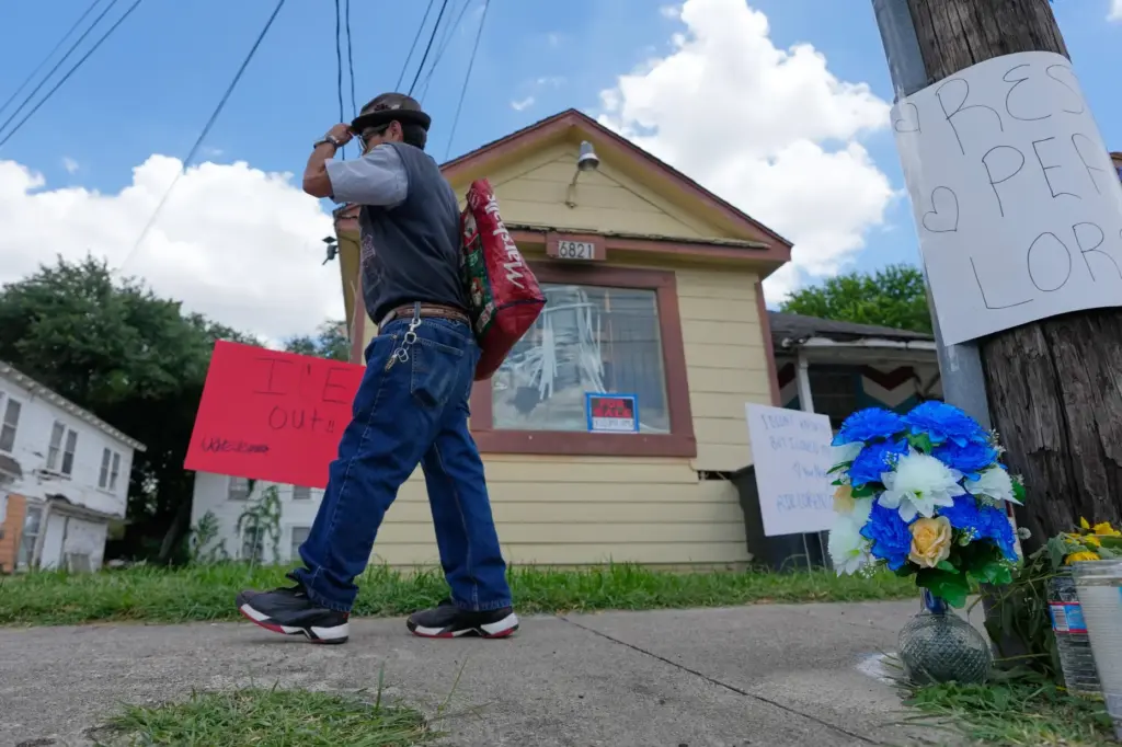 A man walks past a makeshift memorial for Lorenzo Salgado...