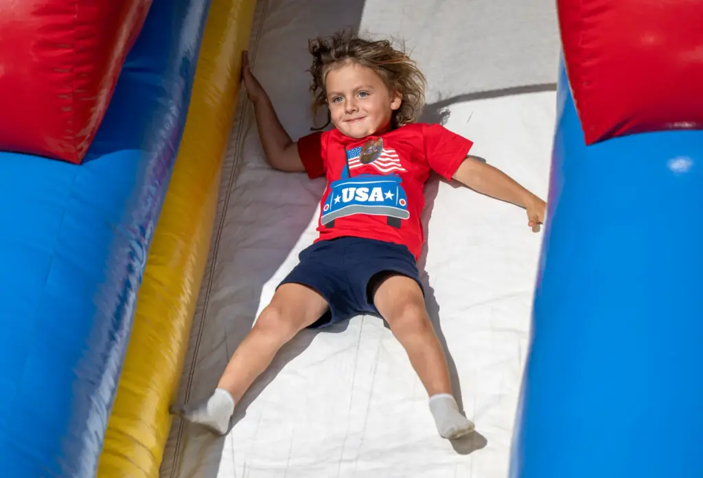 Kellan OâRear, 3, of Costa Mesa slides down an inflatable...