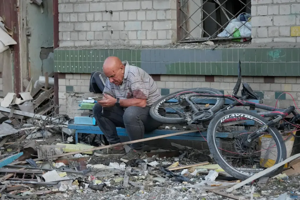 A man reacts at the site of a Russian missile...