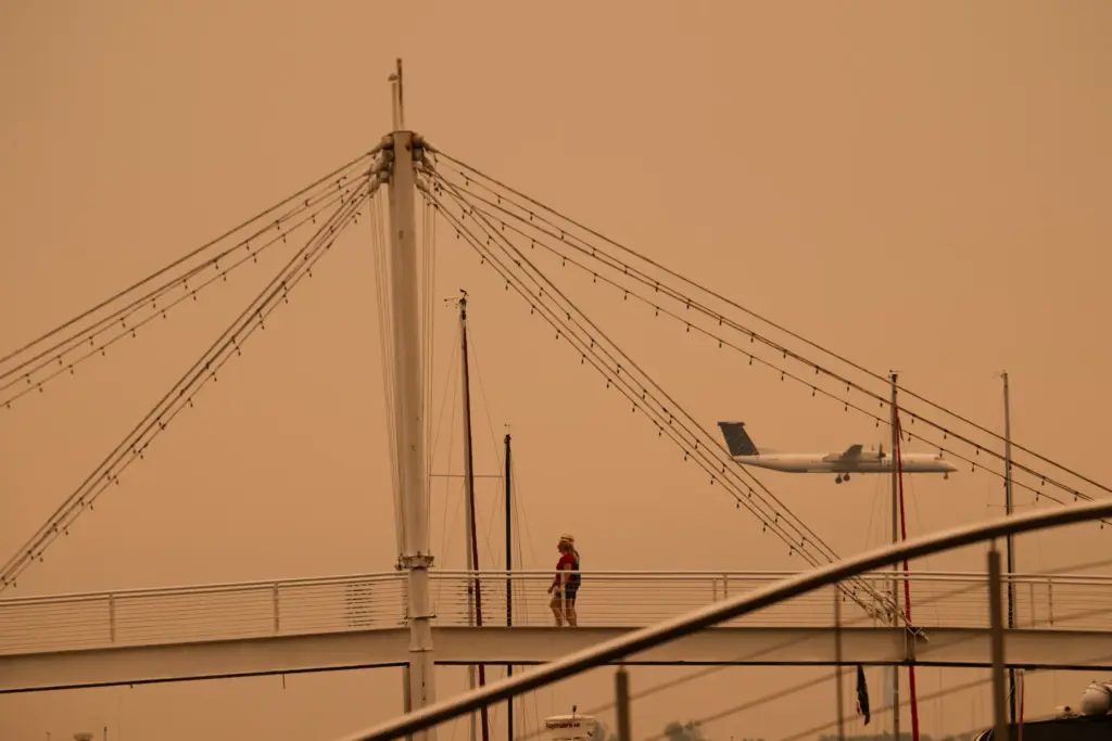 A plane lands at Billy Bishop Toronto City Airport as wildfire smoke fills Toronto.