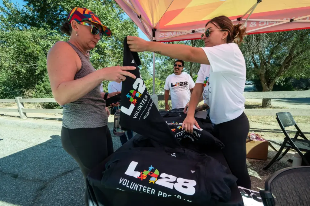 2028 Olympic volunteers pick up their shirts on Tuesday, July...