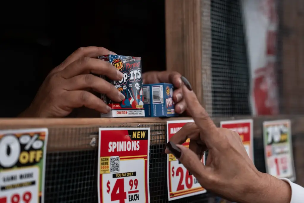Jennifer Aragon, left, shows fireworks packages to a customer at...