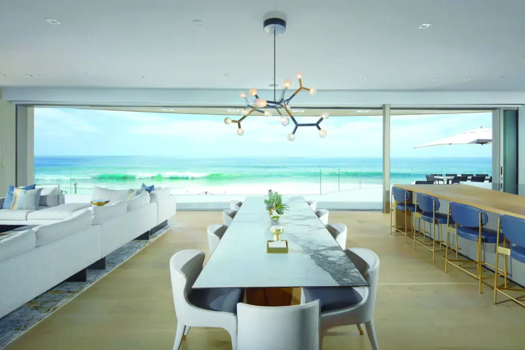 Inside the open-concept great room, a disappearing glass wall frames...