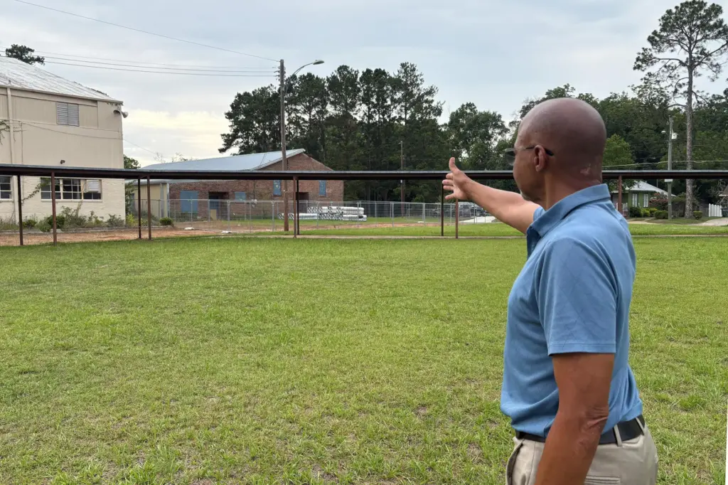 Earl Williams points at the former Douglass High School campus, where a healthcare clinic was planned.