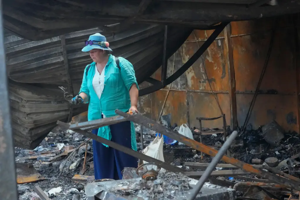 An owner looks at the ruins of a city marketplace following Russian missile attack in Kyiv.