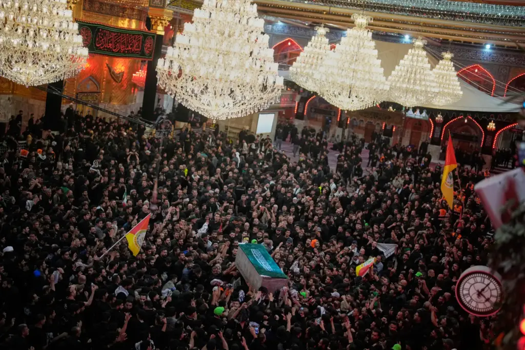 The coffin of Iranian Supreme Leader Ayatollah Ali Khamenei is carried through a crowd.
