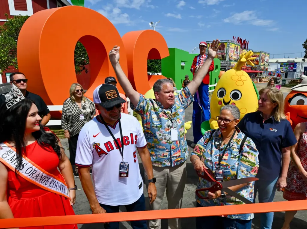 James Canfield, OC Fair & Event Centerâs CEO, center, celebrates...