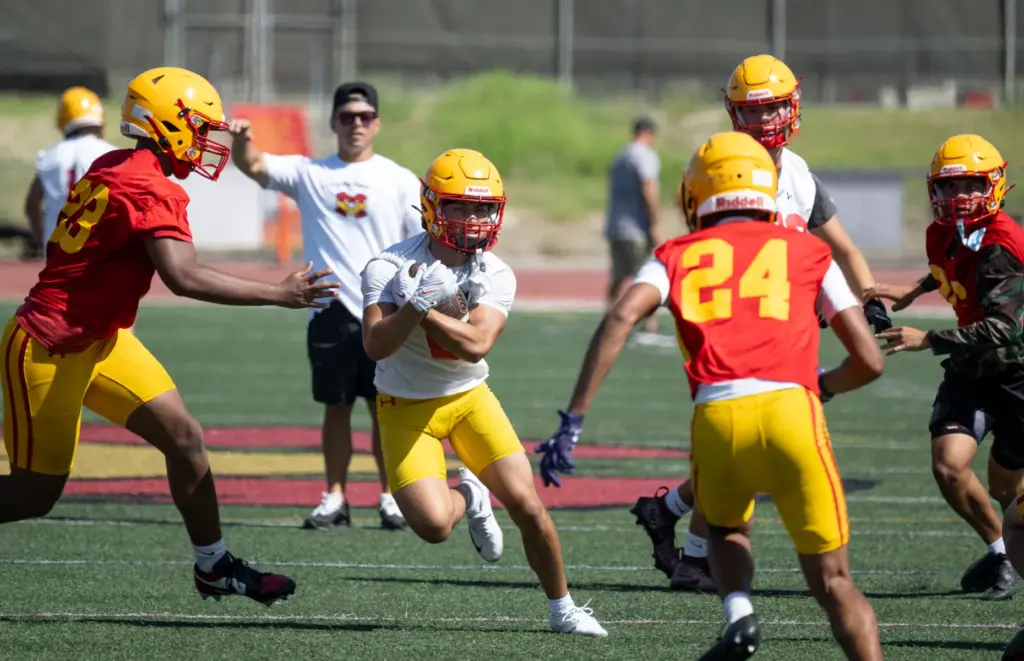 Ther Mission Viejo High School football team runs plays during...