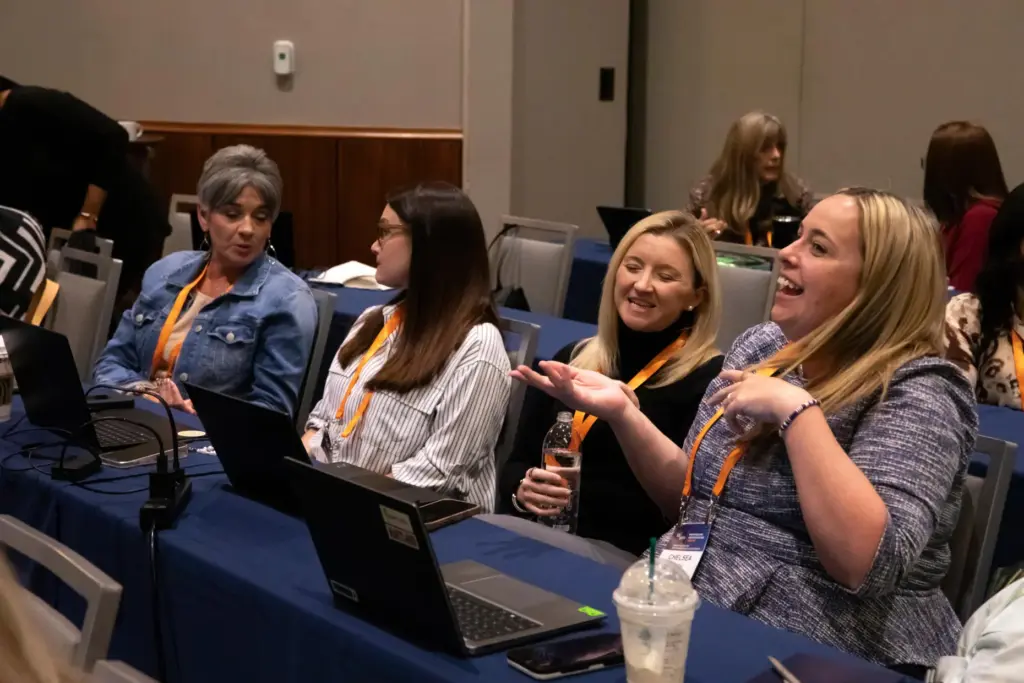 Administrators discuss their use of AI during a training session.