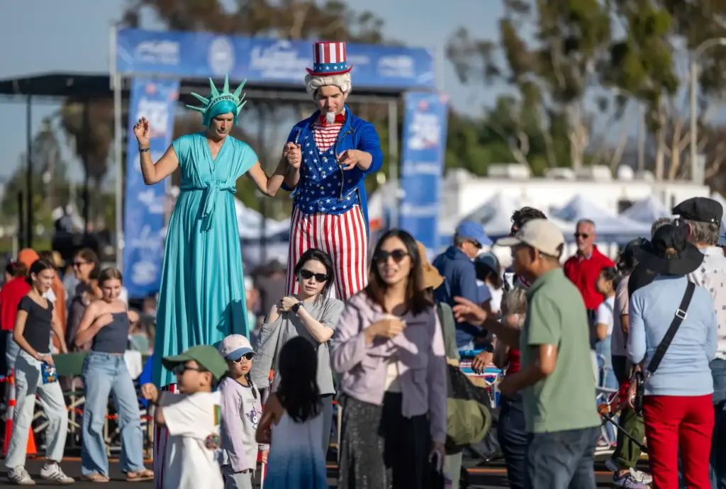 Stilt performers Joy Halverson, left, and Jamie Halverson, dressed as...