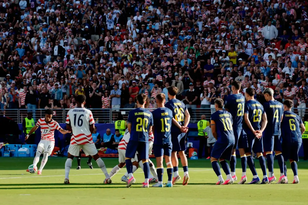 Malik Tillman scores from a free kick against Bosnia.