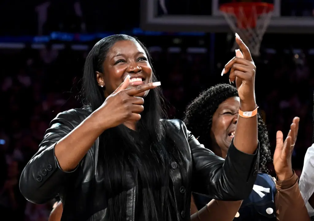 Former Sparks star DeLisha Milton-Jones reacts as her retired jersey...