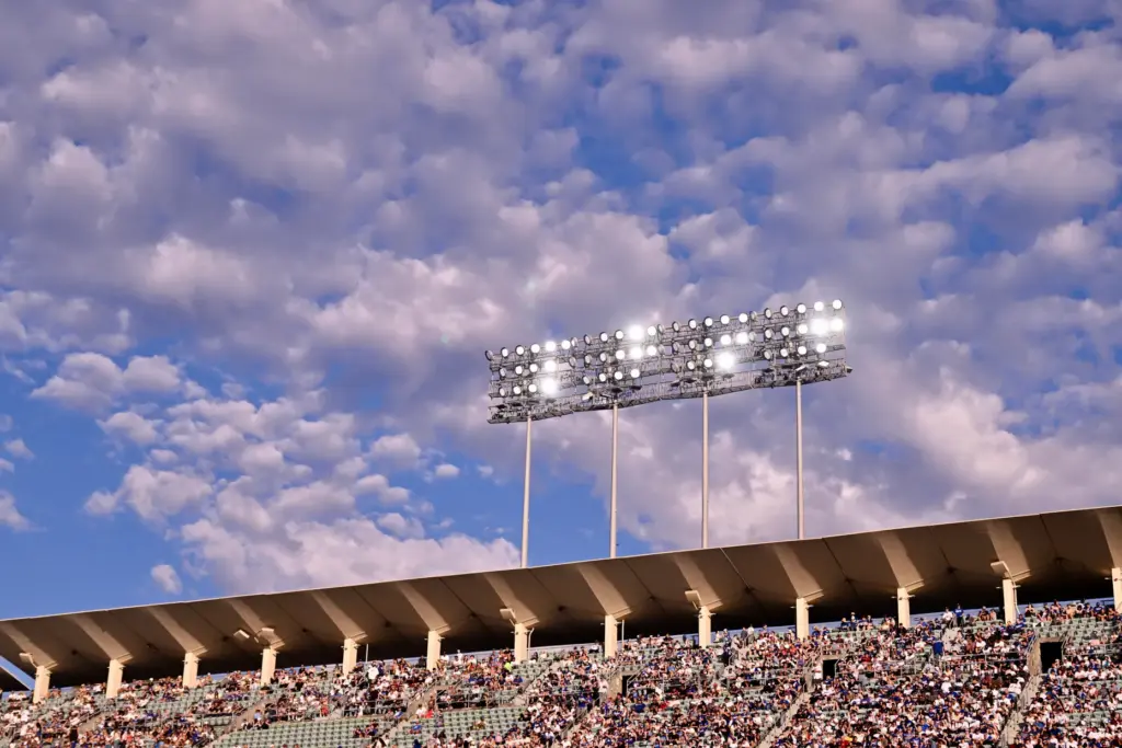 Blue sky and clouds above the stadium lights in the...