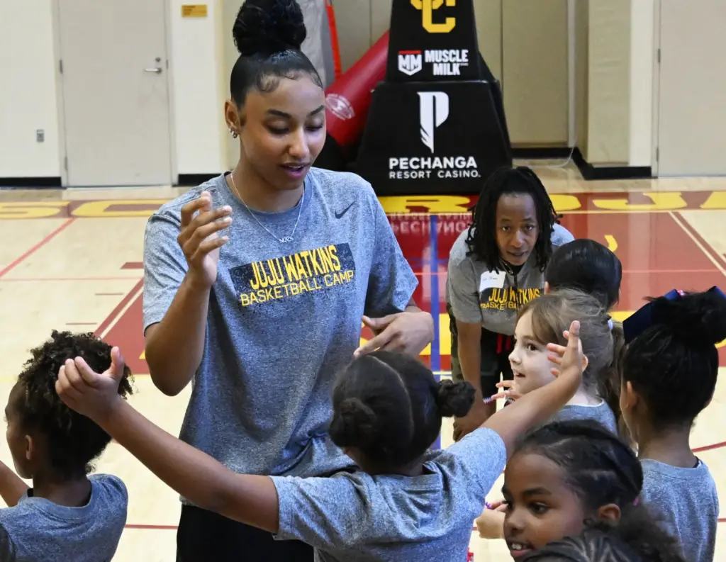 JuJu Watkins gets hugs from campers as she hosts a...