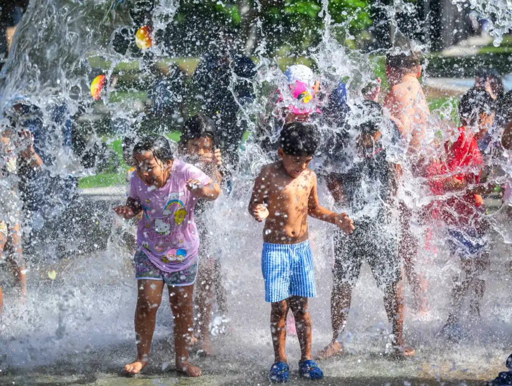 Children get splashed as they play in the new Splash...