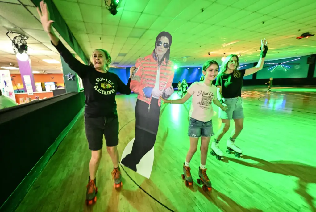 Roxanne Rubio, left, Lucy Cygan, 9, and Julie Saputo skate...