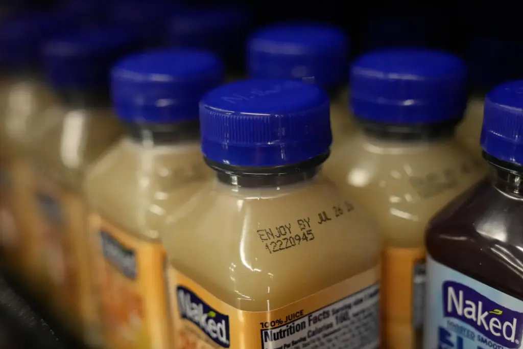 An Enjoy By date is stamped on a drink displayed...