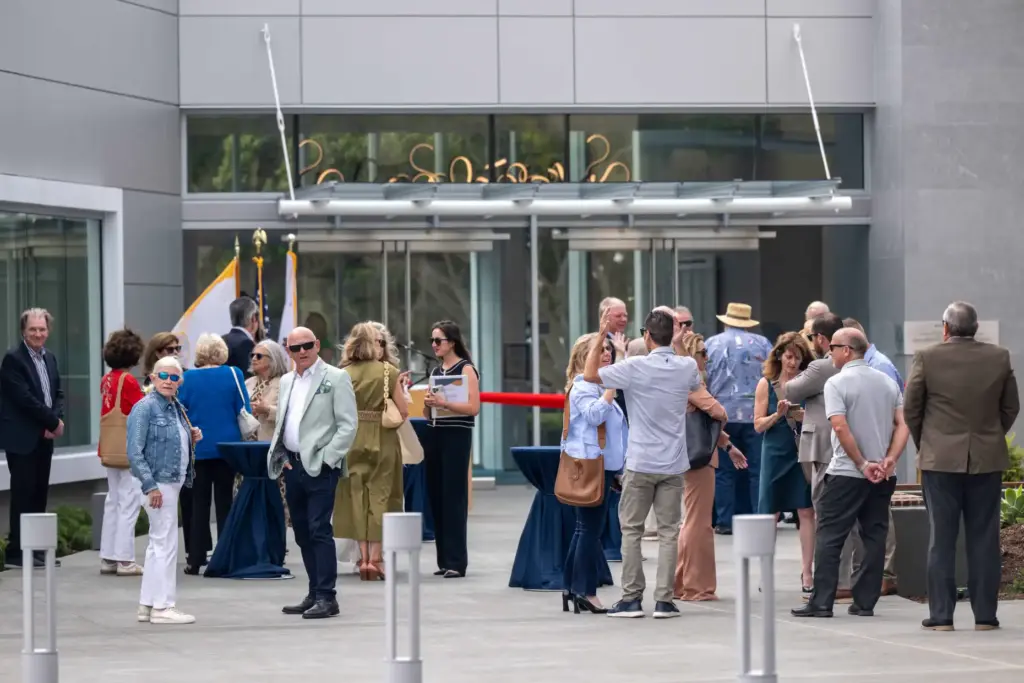 Members of the public and local dignitaries mingle outside the...