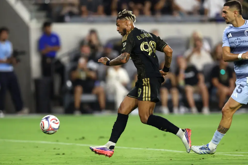 Los Angeles FC forward Denis Bouanga (99) gets past Sporting...