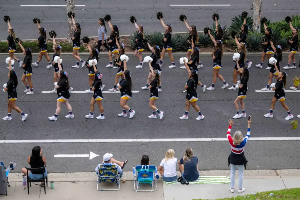 Capistrano Valley High School cheerleaders perform as they walk in...