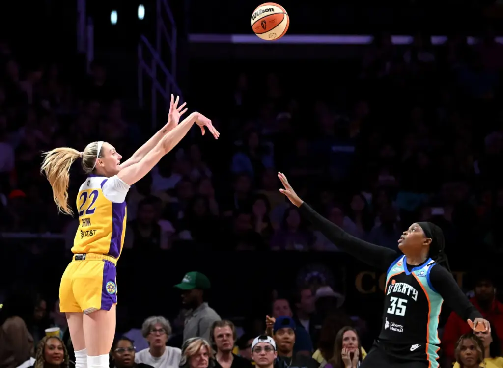 Sparks forward Cameron Brink, left, takes a 3-point shot in...