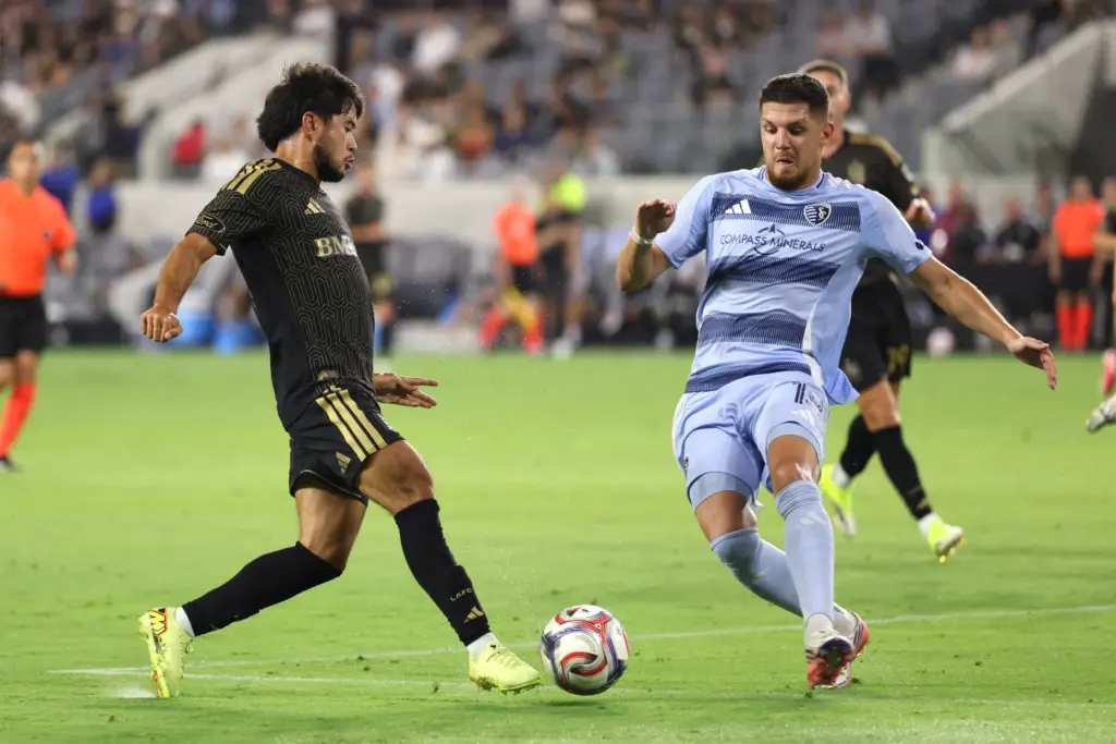 Los Angeles FC midfielder Ryan Raposo, left, moves the ball...