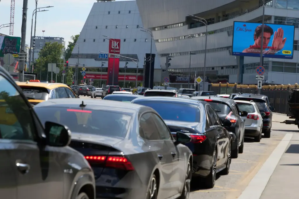 Cars line up at a Lukoil gas station in Moscow,...