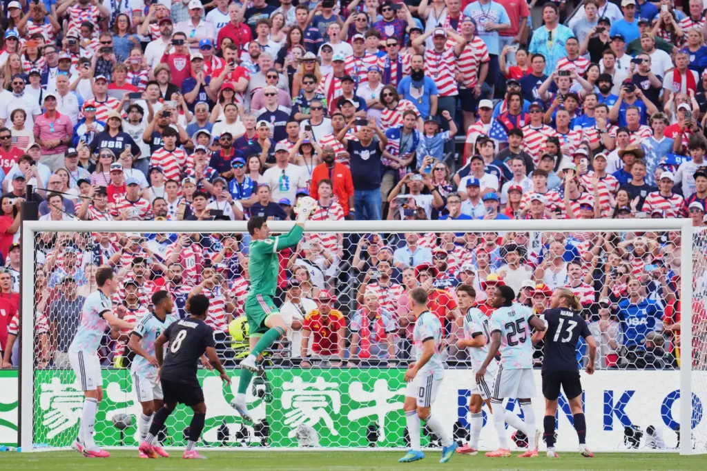 Belgium goalkeeper Thibaut Courtois, center, catches the ball during the...
