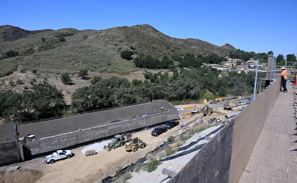 Diego Banda, Caltrans resident engineer, right, views the work on...