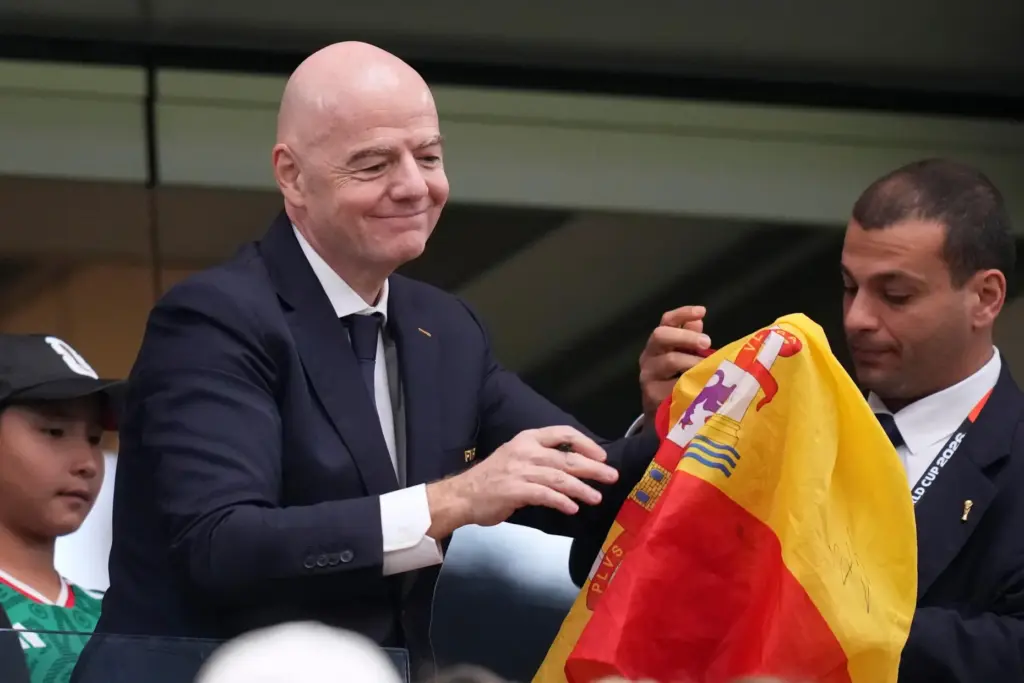 FIFA president Gianni Infantino signs autographs after Spain defeated France.