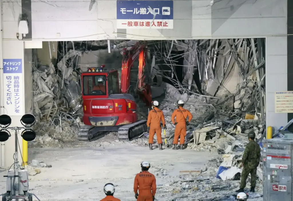 Heavy machinery removes debris at AEON Mall.