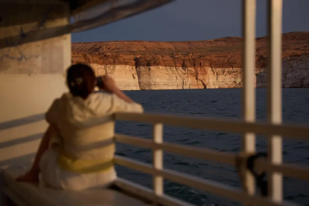 A person takes a picture during a tour on Lake...