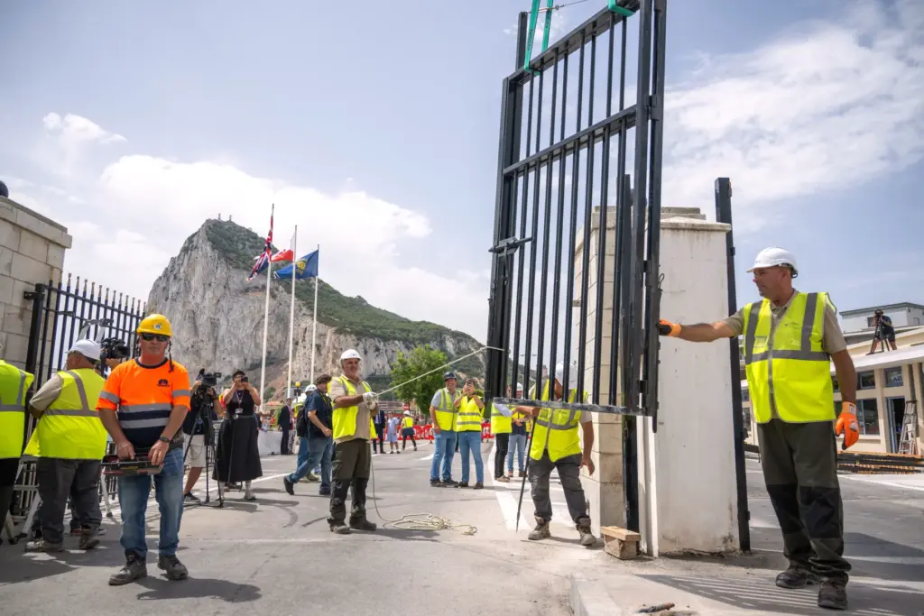 Workers remove the fence separating Gibraltar from Spain.