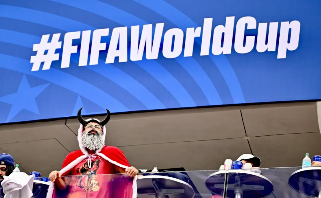 An Austrian fan wearing a costume looks on prior to...