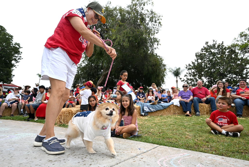 Gloria Watt and her Pomeranian, Chiquita participate in most patriotic...