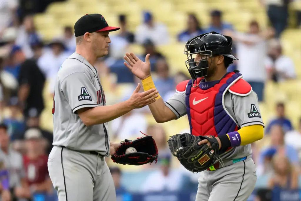 Arizona Diamondbacks’ relief pitcher Paul Sewald, left, and catcher Gabriel...