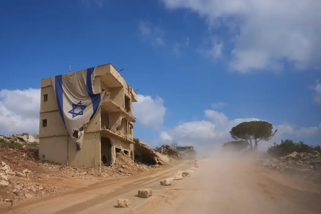 An Israeli flag hangs from a building in an area...