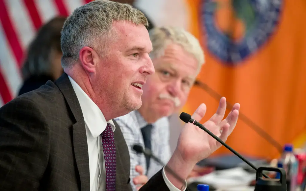 Doug Becht, left, director of the countyâs Office of Care...
